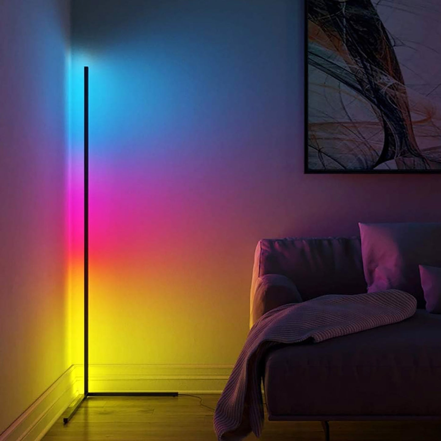 RGB lamp casting a rainbow gradient on a wall next to a bed with pillows.