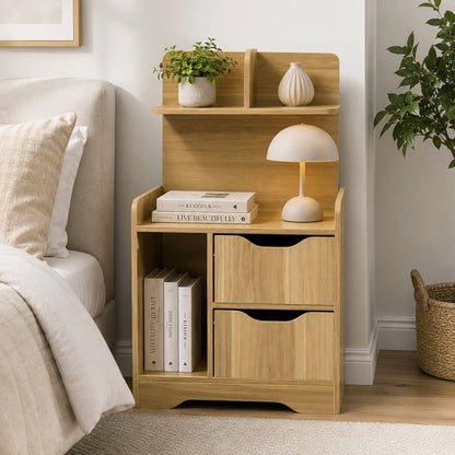 Wooden nightstand with books, lamp, and decor items next to a bed in a bedroom.