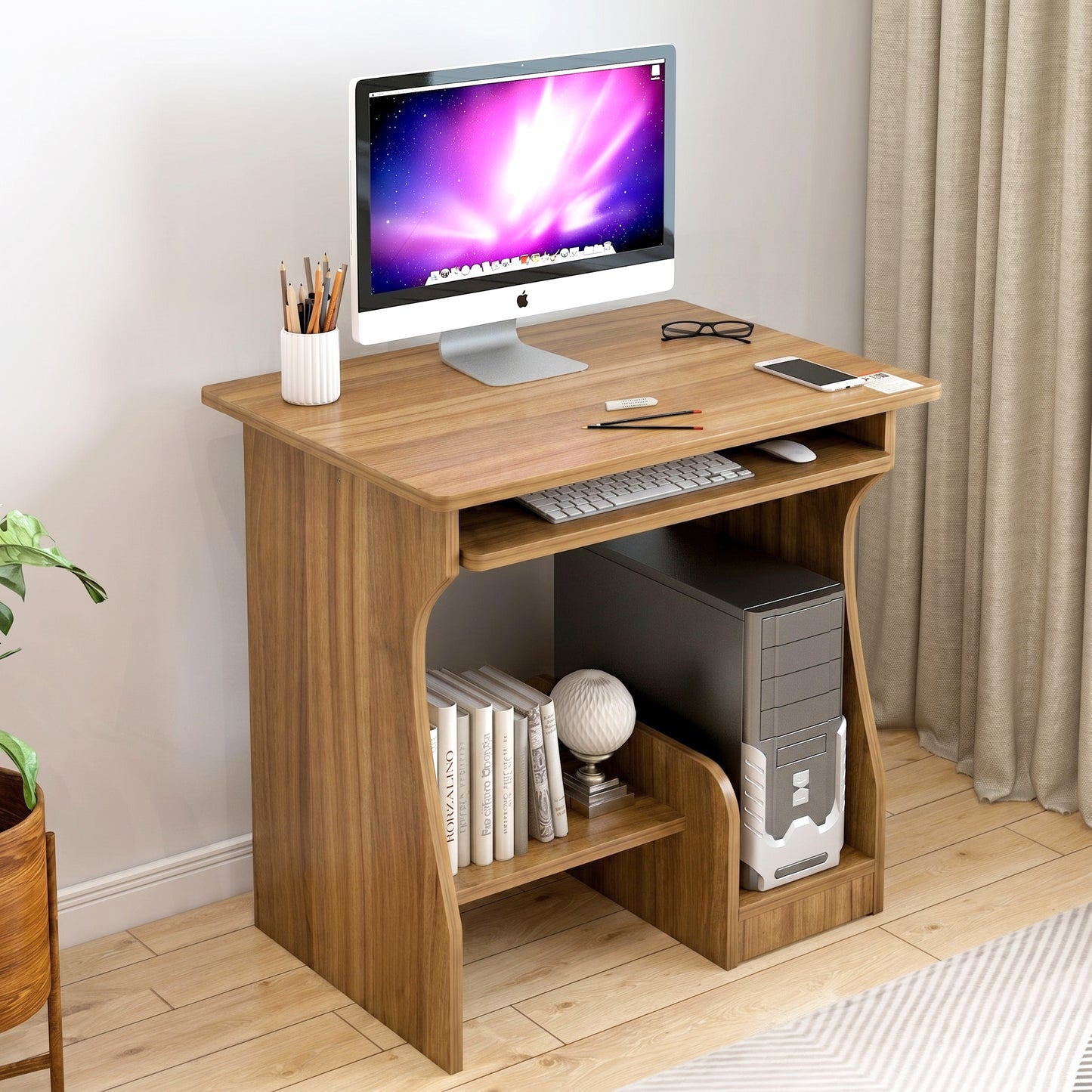 Wooden computer desk with a monitor, keyboard, and other items in a room setting.