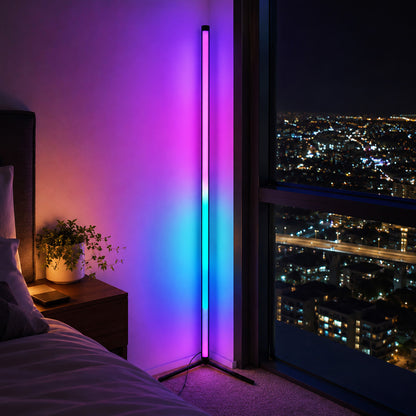 Colorful LED floor lamp in a bedroom with cityscape view